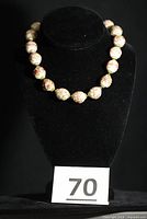 Full necklace displayed on bust showing overall design and length