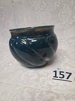 Full view of teal ceramic planter showing gold flecks and swirl design
