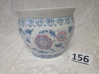 Front view of porcelain planter showing motifs