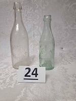 Both vintage bottles side by side showing size and color difference