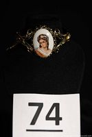 Front view showing porcelain portrait and filigree frame