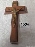 Front view of wooden crucifix showing metal corpus, INRI plaque, scale reference number 189