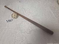 Full view of wooden bat and plastic ball