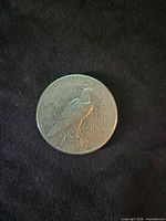Reverse of 1922 Peace Dollar showing eagle on rock with rays and inscriptions