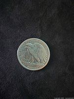 Reverse of 1942 USA dollar coin showing eagle and legends