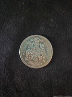 Reverse of 1961 Canadian 50-cent coin showing Canadian coat of arms and denomination