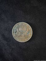 Reverse of 1965 Canadian dollar showing Voyageur canoe design