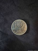 Reverse of 1979 Canada dollar showing Voyageur canoe design