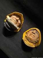 Both Bossons head plaques side by side on dark background