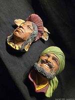 Both Bossons plaster heads on black cloth