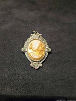 Front view showing cameo profile and rhinestone frame