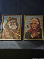 Both framed needlepoint portraits side by side