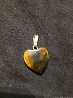 Front view of tiger's eye heart pendant showing stone and bail