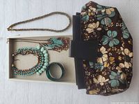 Full lot overview showing clutch, three necklaces, bangle and display tray