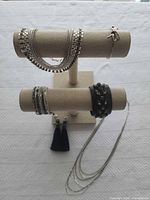 Full lot showing display stand with bracelets, necklaces, earrings
