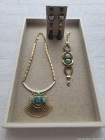 Full set on linen tray showing necklace, bracelet and earring stand
