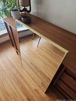 Front view of rectangular mirror leaning against wooden console