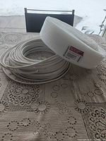Foam sill plate gasket roll and coil of wire on table