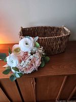 Basket and bouquet together on surface