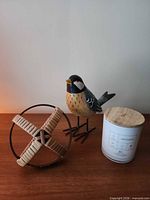 All three items grouped: wooden bird, rattan orb, W+L candle