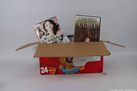 Open box showing assorted disc cases, visible titles Little Boy Lost and a Japanese female album