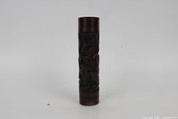 Full front view of carved wooden cylinder vase