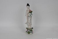 Front view of porcelain Guanyin figurine with lotus flower and base