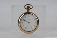 Front view of gold-filled pocket watch showing dial, hands and crystal