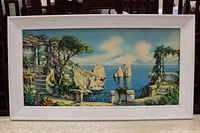 Front view of framed coastal landscape print in white frame