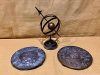 Astrolabe and two cast brass disks displayed together