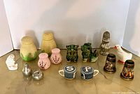 Group shot of all salt & pepper shakers in lot