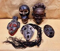 Group shot of all five masks on fabric background