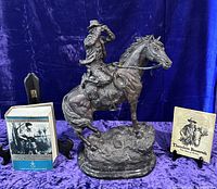 Full lot: sculpture centered, book left, pamphlet right