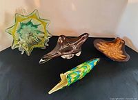 Group of four art glass pieces on table