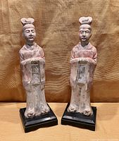 Full view of both plaster Chinese funerary figures on bases