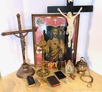 group shot of all items including crosses, framed picture, censer, books, icons