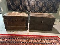 Both trunks closed side by side showing exterior condition and size comparison