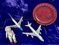 Group shot of both aircraft models, bisque doll, and alphabet plate