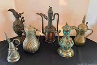 Group shot of all seven ewers on black cloth