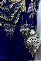 Three Moroccan-style hanging lanterns with beads and filigree metal