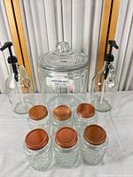 Group shot of all nine glass containers arranged for scale and completeness