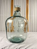 Full view of aqua glass demijohn showing overall shape and color
