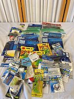Overview of all packaged fishing tackle laid out on table