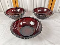 Three ruby red pressed glass bowls top view
