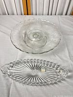 Cake stand by oval platter on table