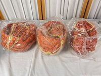 Three turbans in clear plastic packaging on table