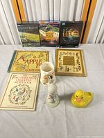 Overview of books, DVDs, jug, figurines on table