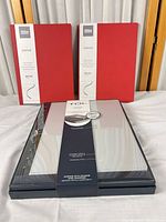 Lot overview showing two red journals and packaged TUL notebook