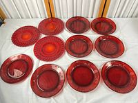 Group shot of all red glass plates on table