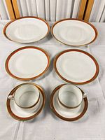 Overhead view of full eight-piece set: two dinner plates, two salad plates, two teacups on saucers